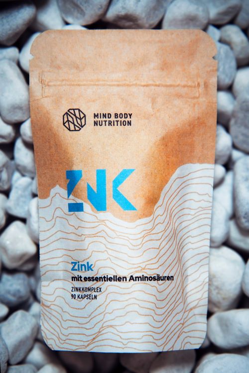 Unser Zink in kompostierbarer Verpackung auf steinigem Hintergrund.